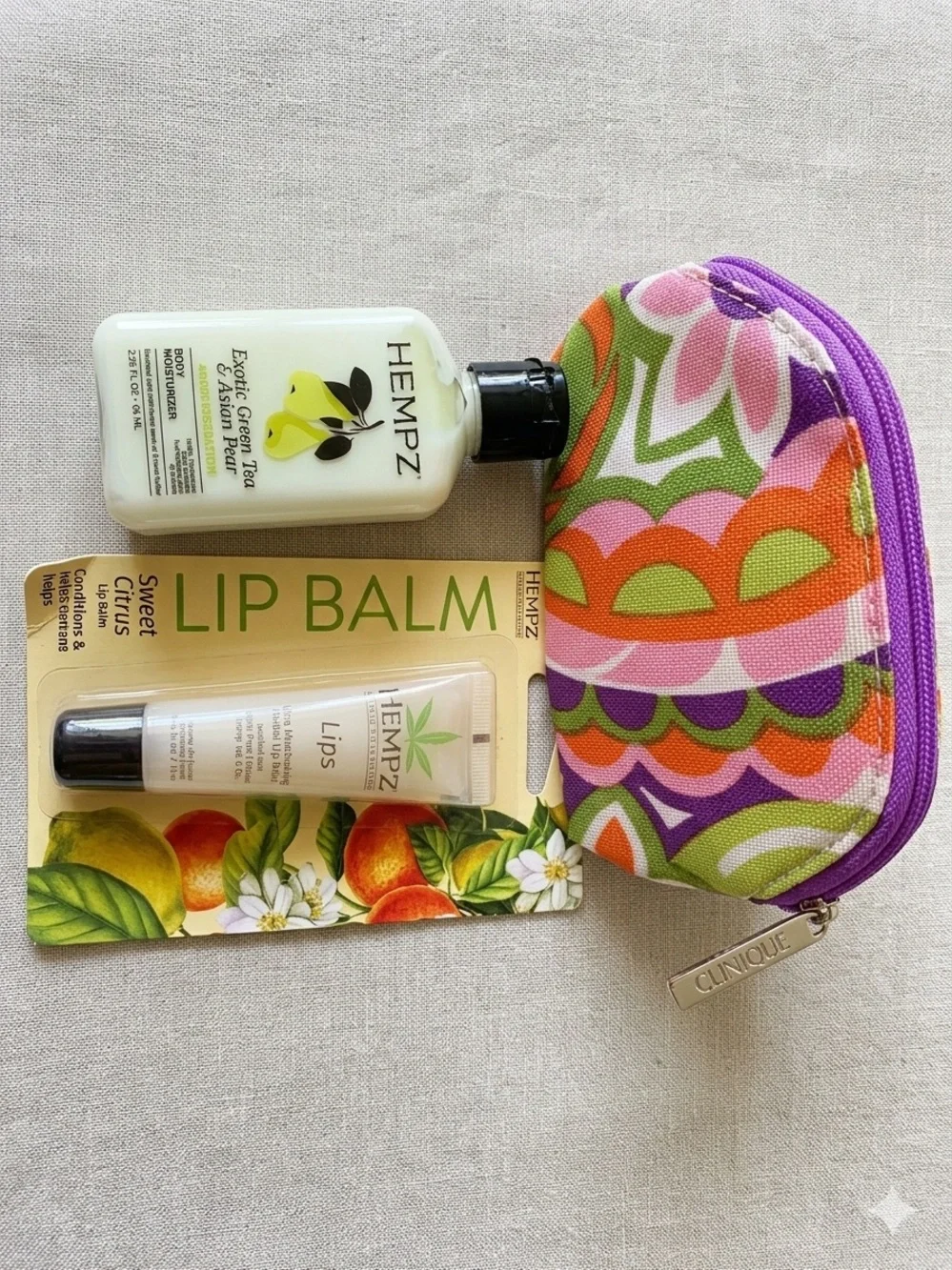 Hempz Green Tea & Asian Pear lotion and Hempz Citrus Lip Balm and Clinique pouch
